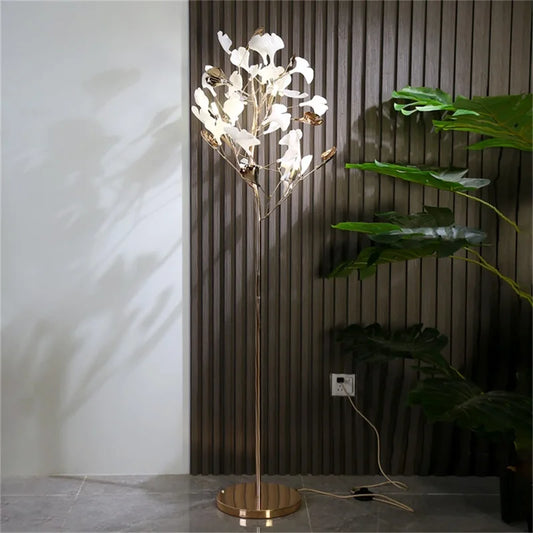 J.Y.R® Ginkgo Flower Floor Lamp - Nature-inspired design with ginkgo leaf shape and modern LED lighting, positioned in a cozy corner.